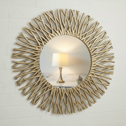 A round wall mirror with a decorative sunburst frame made of slender, light wood-like branches radiating outward, shown against a plain white background.